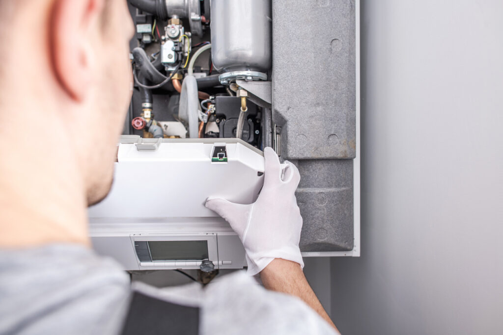 Close up of an HVAC technician repairing a furnace